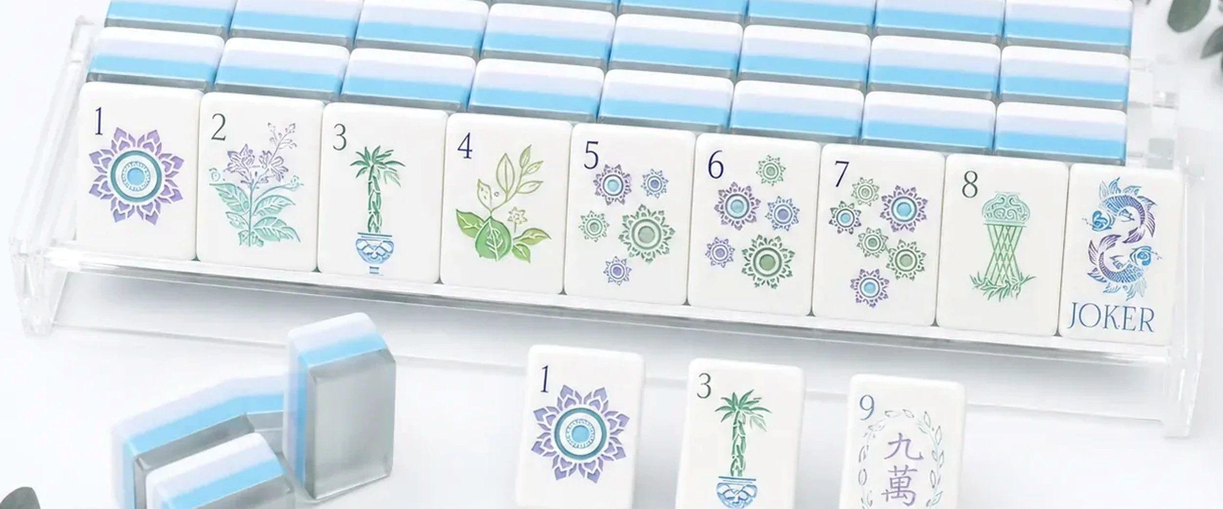 Blue and green American Mahjong tiles arranged on a game table